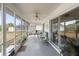 Spacious screened porch with seating area and ceiling fan at 2720 S Biscayne Dr, North Port, FL 34287