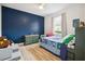 bedroom with blue accent wall, built-in shelving, and twin bed at 2797 Harvest Dr, Sarasota, FL 34240