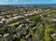 Aerial view of community near the coast, showcasing numerous homes and green spaces at 304 Pine Run Dr, Osprey, FL 34229
