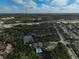 Aerial view of community with tennis courts and pool at 304 Pine Run Dr, Osprey, FL 34229