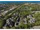 Aerial perspective of community with lush landscaping and ocean views at 304 Pine Run Dr, Osprey, FL 34229