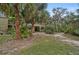 Private backyard with lush landscaping and tropical plants at 304 Pine Run Dr, Osprey, FL 34229