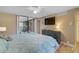 Primary bedroom with private access to patio and large TV at 304 Pine Run Dr, Osprey, FL 34229