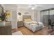Cozy bedroom with wood floors, a ceiling fan, and plenty of closet space at 304 Pine Run Dr, Osprey, FL 34229