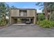 Exterior view of a two-story condo with carport and landscaping at 304 Pine Run Dr, Osprey, FL 34229