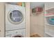 Convenient laundry closet with washer, dryer, and shelving at 304 Pine Run Dr, Osprey, FL 34229