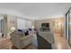 Bright living room with hardwood floors, comfy furniture, and large windows at 304 Pine Run Dr, Osprey, FL 34229