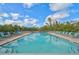 Inviting community pool with lounge chairs and umbrellas at 304 Pine Run Dr, Osprey, FL 34229
