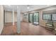 Bright sunroom with wood-look floors, sliding glass doors, and ceiling fan at 304 Pine Run Dr, Osprey, FL 34229