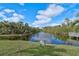 Serene waterfront view with lush greenery and a peaceful atmosphere at 304 Pine Run Dr, Osprey, FL 34229