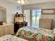 Bedroom with twin beds, dresser, and view of the patio at 305 47Th Avenue W Dr # 143, Bradenton, FL 34207
