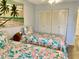 Bedroom with twin beds, large closet and beach artwork at 305 47Th Avenue W Dr # 143, Bradenton, FL 34207
