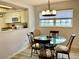Dining area with glass-top table and four chairs at 305 47Th Avenue W Dr # 143, Bradenton, FL 34207
