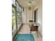 Enclosed patio with seating for two and view of garden at 305 47Th Avenue W Dr # 143, Bradenton, FL 34207