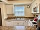 White kitchen cabinets, granite countertops, and stainless steel appliances at 305 47Th Avenue W Dr # 143, Bradenton, FL 34207