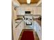 White kitchen with granite countertops and wood floors at 305 47Th Avenue W Dr # 143, Bradenton, FL 34207