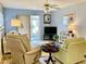 Living room with two armchairs and access to patio at 305 47Th Avenue W Dr # 143, Bradenton, FL 34207