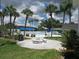 Community pool with patio tables, grill, and palm trees at 305 47Th Avenue W Dr # 143, Bradenton, FL 34207