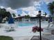 Relaxing community pool area with patio furniture and lush landscaping at 305 47Th Avenue W Dr # 143, Bradenton, FL 34207