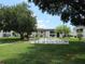 Community shuffleboard court surrounded by green grass and mature trees at 305 47Th Avenue W Dr # 143, Bradenton, FL 34207