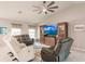 Living room with comfy seating, large TV, and a ceiling fan at 3164 Lotus Rd, North Port, FL 34291