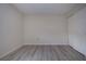 Simple bedroom with neutral walls, wood-look vinyl flooring, and a sliding door closet at 3259 Beneva Rd # 102, Sarasota, FL 34232