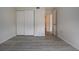 Simple bedroom with neutral walls, wood-look vinyl flooring, and a door to hallway at 3259 Beneva Rd # 102, Sarasota, FL 34232