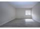 Spacious bedroom with neutral walls, wood-look vinyl flooring, and a large window at 3259 Beneva Rd # 102, Sarasota, FL 34232