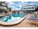 Inviting community pool with lounge chairs and patio furniture at 3259 Beneva Rd # 102, Sarasota, FL 34232
