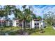 Condo building with lush landscaping and palm trees in a sunny location at 3259 Beneva Rd # 102, Sarasota, FL 34232