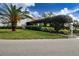 Condo building with lush landscaping and palm trees at 3259 Beneva Rd # 102, Sarasota, FL 34232