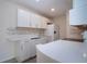 Modern white kitchen with breakfast bar and stainless steel appliances at 3259 Beneva Rd # 102, Sarasota, FL 34232