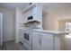 Bright eat-in kitchen, features white cabinetry, updated appliances, and tile backsplash at 3259 Beneva Rd # 102, Sarasota, FL 34232