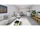 Bright living room features stylish sofa, coffee table, and dining area at 3259 Beneva Rd # 102, Sarasota, FL 34232
