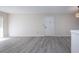 Spacious living area featuring light walls and gray vinyl flooring at 3259 Beneva Rd # 102, Sarasota, FL 34232