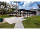 Community pool area with pergola and lounge chairs at 3259 Beneva Rd # 102, Sarasota, FL 34232