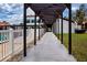 Walkway to pool area with pergola overhead at 3259 Beneva Rd # 102, Sarasota, FL 34232