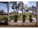 Enjoy the view from this screened patio, featuring potted plants and a grassy area at 3259 Beneva Rd # 102, Sarasota, FL 34232