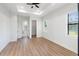 Spacious bedroom with wood-look floors and access to bathroom and closet at 3782 Horace Ave, North Port, FL 34286