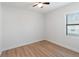 Spacious bedroom with light walls, wood-look floors, and a window with blinds at 3782 Horace Ave, North Port, FL 34286