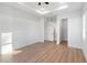 Bright bedroom with wood-look floors and access to bathroom and closet at 3782 Horace Ave, North Port, FL 34286