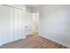 Bright bedroom with wood-look floors and double doors leading to a closet at 3782 Horace Ave, North Port, FL 34286
