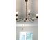 Black chandelier with five candle-style lights at 3782 Horace Ave, North Port, FL 34286