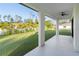 Large covered patio overlooking the backyard with a view of trees at 3782 Horace Ave, North Port, FL 34286