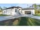 Contemporary home with gray paver driveway and lush lawn at 3782 Horace Ave, North Port, FL 34286