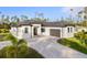 Modern single-story home with gray paver driveway and landscaping at 3782 Horace Ave, North Port, FL 34286
