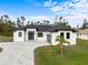 Modern two-story home with gray roof and paver driveway at 3782 Horace Ave, North Port, FL 34286