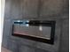 Modern electric fireplace with gray tile surround at 3782 Horace Ave, North Port, FL 34286