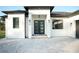 Modern front entrance with black double doors and gray paver walkway at 3782 Horace Ave, North Port, FL 34286