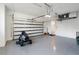 Bright garage with an overhead door and lawnmower at 3782 Horace Ave, North Port, FL 34286